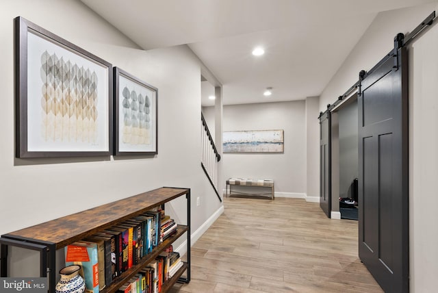 12019 Wandabury Rd, Oakton, VA 22124 - hallway with a barn door, recessed lighting, light wood-type flooring, baseboards, and stairway