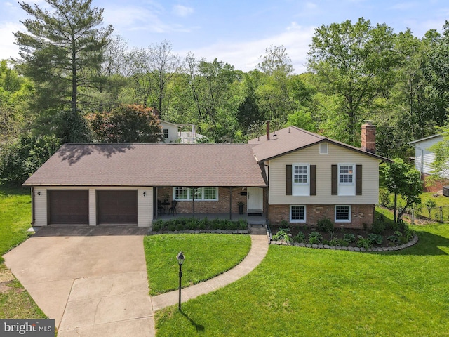 split level home featuring brick siding, an attached garage, driveway, and a front yard