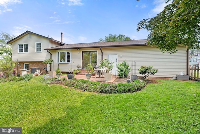 back of property with a lawn, cooling unit, and a patio