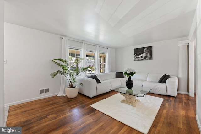living area with baseboards, visible vents, and dark wood-style floors