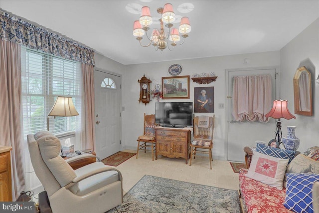 living room with baseboards and a chandelier