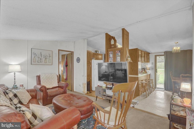 living room with a textured ceiling, a notable chandelier, and vaulted ceiling