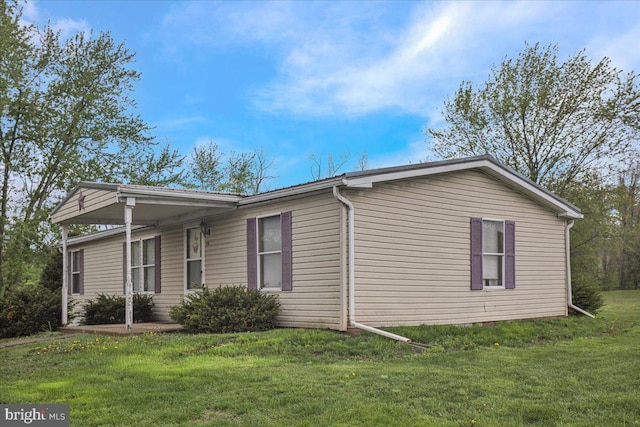 view of side of home featuring a yard