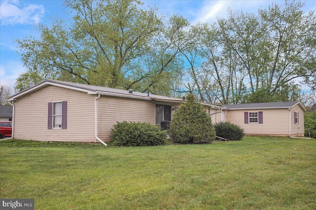 rear view of property with a lawn