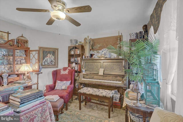 sitting room featuring ceiling fan and carpet flooring