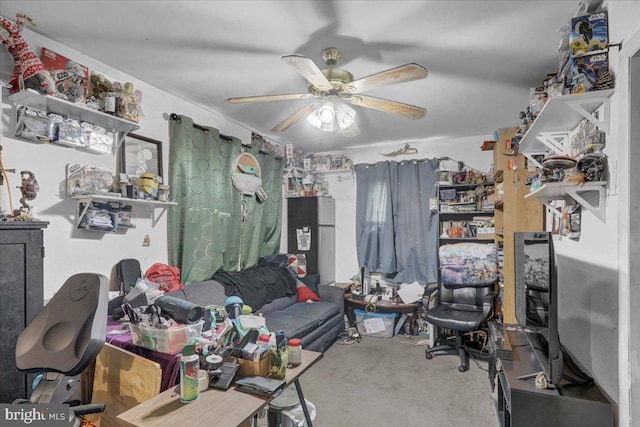 interior space with a ceiling fan and concrete flooring