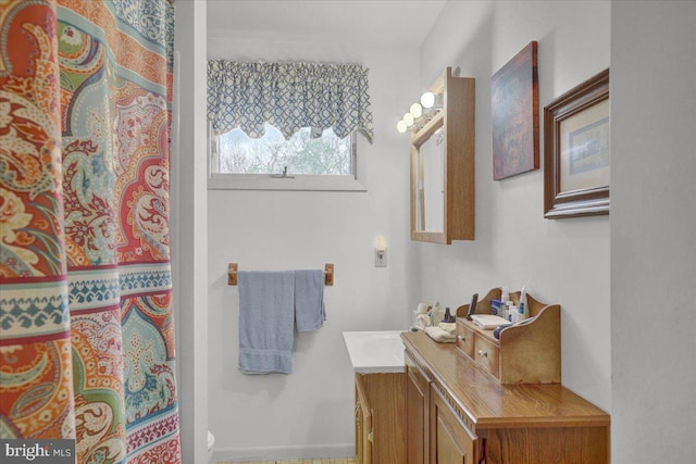 full bath with vanity, baseboards, curtained shower, and toilet