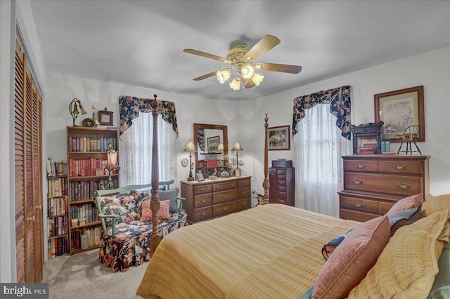 bedroom featuring a closet, carpet flooring, a ceiling fan, and multiple windows