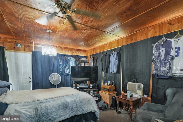 carpeted bedroom featuring wood ceiling and wooden walls