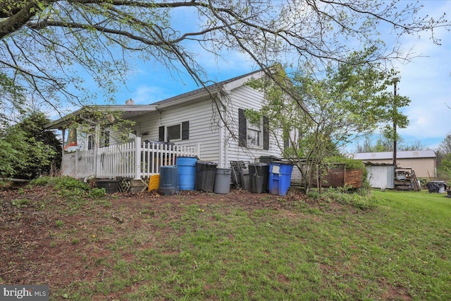 view of home's exterior featuring a yard and a deck