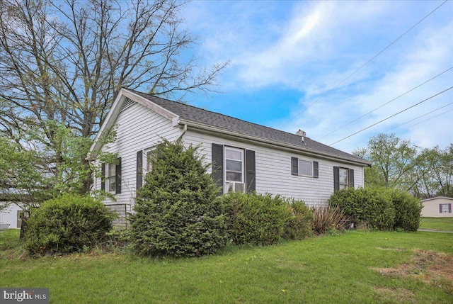 view of side of property with a lawn