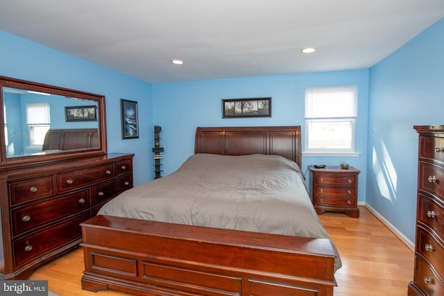 bedroom featuring multiple windows, recessed lighting, and light wood-style flooring