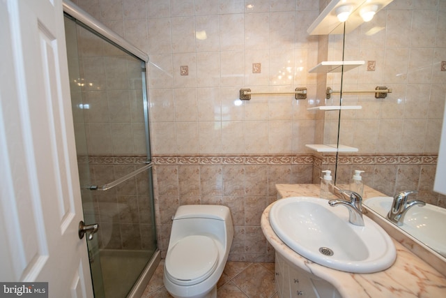 full bathroom with vanity, toilet, tile patterned floors, tile walls, and a shower stall