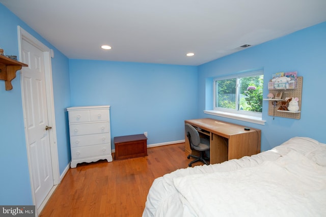 bedroom with baseboards, recessed lighting, and wood finished floors