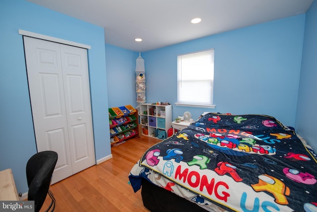 bedroom featuring recessed lighting, a closet, and light wood-type flooring