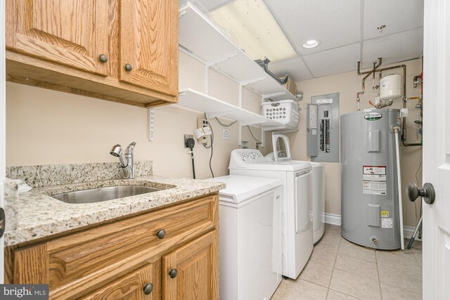 washroom with water heater, washer and clothes dryer, electric panel, cabinet space, and light tile patterned flooring