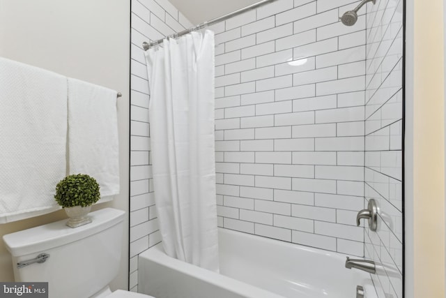 bathroom featuring shower / bath combo and toilet