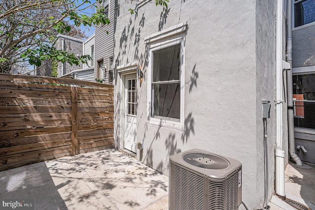 view of patio / terrace featuring fence and cooling unit