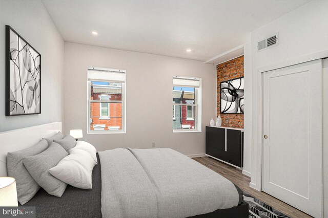 bedroom featuring recessed lighting, visible vents, multiple windows, and wood finished floors