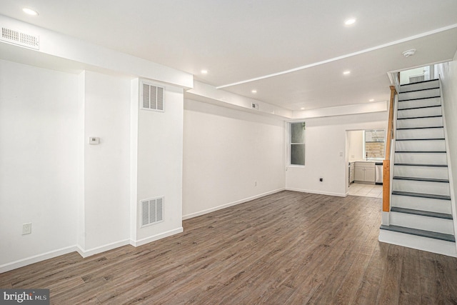 unfurnished living room with recessed lighting, stairs, wood finished floors, and visible vents