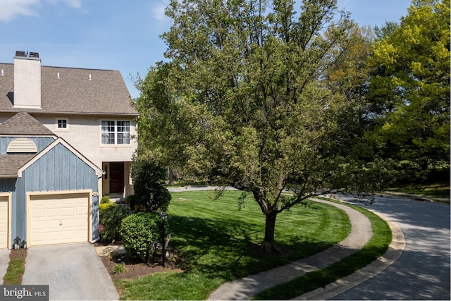 view of property exterior with a chimney, aphalt driveway, a shingled roof, board and batten siding, and a yard