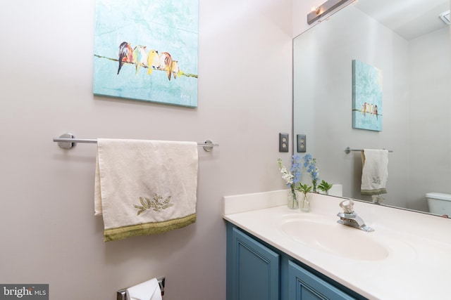 bathroom featuring toilet and vanity