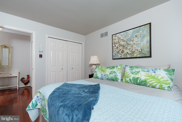 bedroom with a closet, visible vents, and hardwood / wood-style flooring