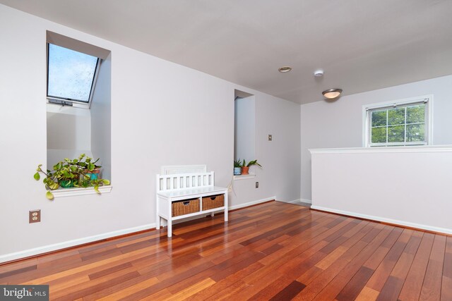 unfurnished room featuring baseboards, hardwood / wood-style floors, and recessed lighting