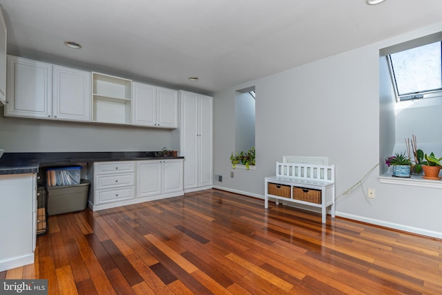 kitchen with open shelves, dark wood-type flooring, recessed lighting, white cabinets, and dark countertops