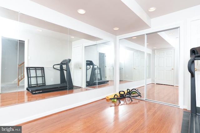 workout area featuring wood finished floors and recessed lighting