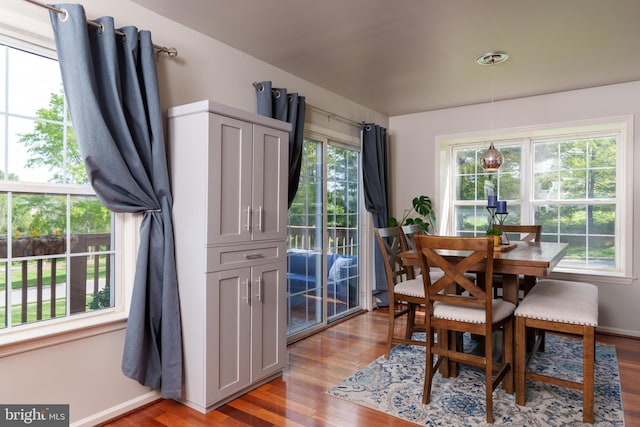 dining area with baseboards and light wood-style floors