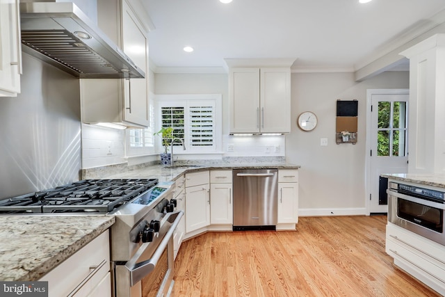 3207 19th St N, Arlington, VA 22201 - kitchen featuring appliances with stainless steel finishes, exhaust hood, a sink, healthy amount of natural light, and crown molding