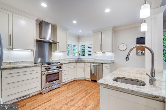 3207 19th St N, Arlington, VA 22201 - kitchen featuring wall chimney range hood, stainless steel appliances, a sink, crown molding, and white cabinetry