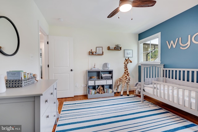 3207 19th St N, Arlington, VA 22201 - bedroom with wood finished floors, a nursery area, a ceiling fan, and baseboards