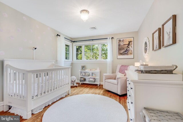 3207 19th St N, Arlington, VA 22201 - bedroom featuring light wood-type flooring and a crib