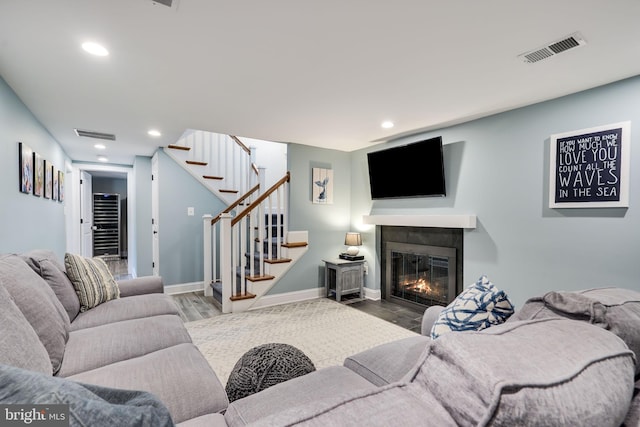 3207 19th St N, Arlington, VA 22201 - living area featuring stairway, wood finished floors, a fireplace with flush hearth, recessed lighting, and beverage cooler