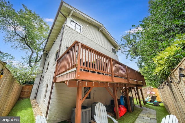 3207 19th St N, Arlington, VA 22201 - rear view of house with brick siding, central AC unit, a wooden deck, and a fenced backyard