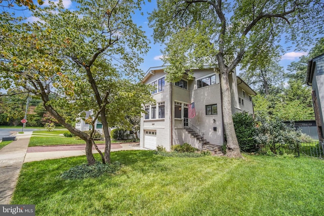 3207 19th St N, Arlington, VA 22201 - view of front of property with a garage, a front yard, concrete driveway, stairway, and brick siding