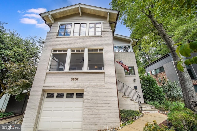 3207 19th St N, Arlington, VA 22201 - view of front of home featuring brick siding, stairway, a sunroom, and a garage