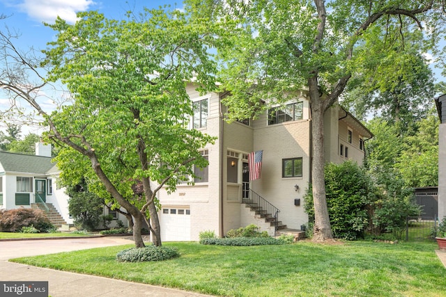 3207 19th St N, Arlington, VA 22201 - view of front of house with stairway, brick siding, a garage, concrete driveway, and a front yard