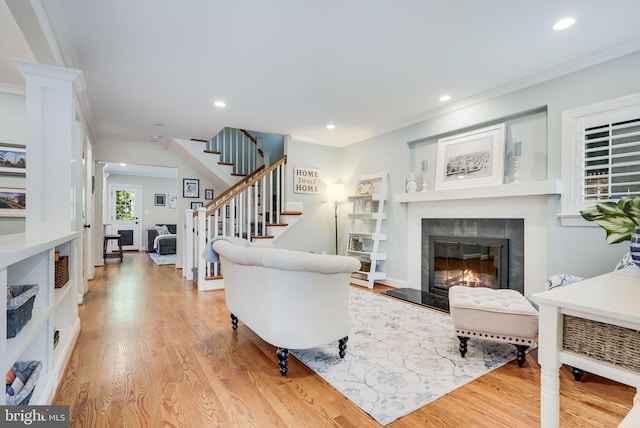 3207 19th St N, Arlington, VA 22201 - living room featuring ornamental molding, stairway, light wood-type flooring, recessed lighting, and a glass covered fireplace
