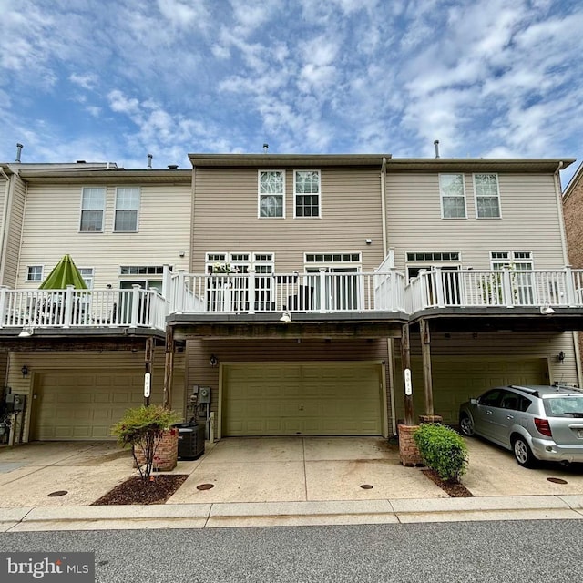 5012 Strawbridge Ter, Perry Hall, MD 21128 - back of house with an attached garage, cooling unit, and concrete driveway