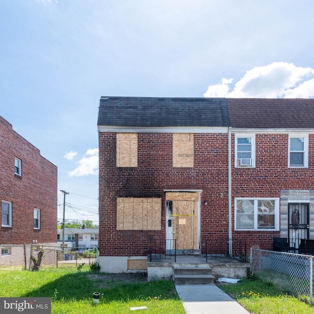 multi unit property featuring brick siding, a shingled roof, and fence