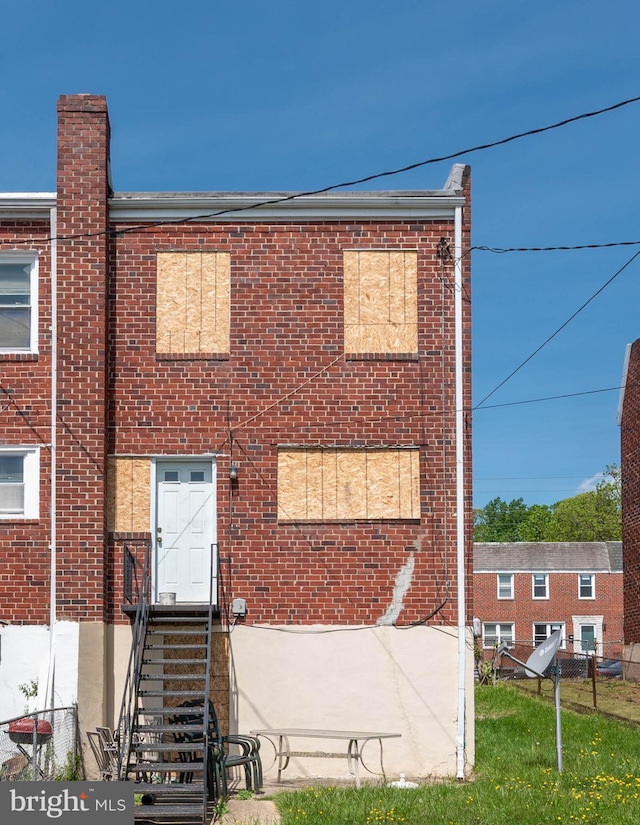 view of property with brick siding and a chimney