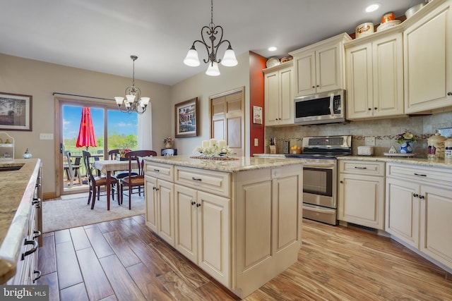 239 Abishire Way, Chambersburg, PA 17202 - kitchen featuring appliances with stainless steel finishes, an inviting chandelier, recessed lighting, light wood-style flooring, and cream cabinetry