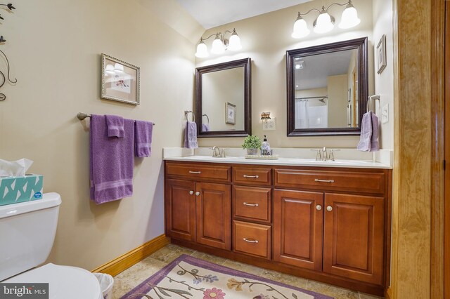 239 Abishire Way, Chambersburg, PA 17202 - bathroom featuring double vanity, toilet, baseboards, and a sink