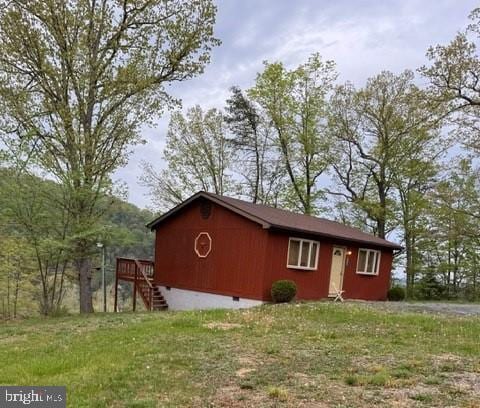 exterior space featuring a yard, crawl space, stairway, and a deck