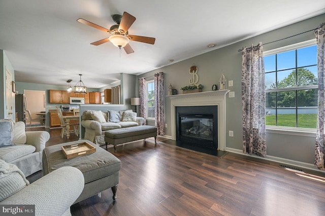 278 Otter Way, Frederica, DE 19946 - living area with dark wood finished floors, ceiling fan with notable chandelier, baseboards, a fireplace with flush hearth, and visible vents