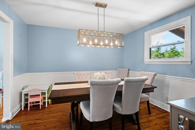 dining space with wood finished floors