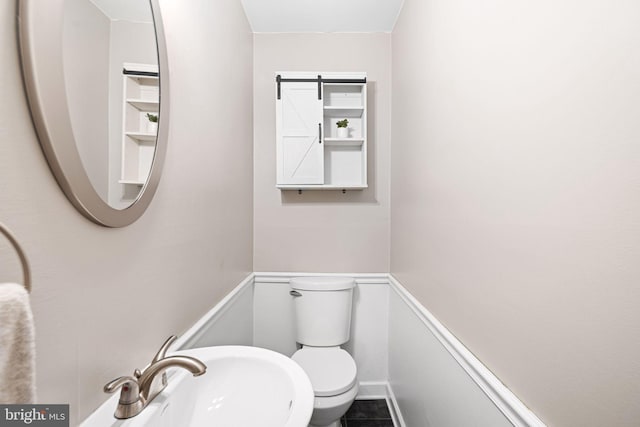 bathroom featuring toilet and a sink